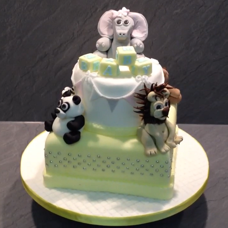 Christening or birthday cake with Elephant, Panda, Lion and a teddy on a 2 tier cake