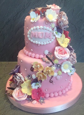 Pink 2 tier birthday cake with mixed flower cascade