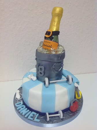 White chocolate Champagne bottle, on a 2-tier cake, in this case with gym equipment.  The 2nd tier of cake is decorated as an ice bucket.