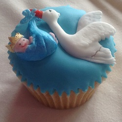 Stork flying with baby cupcake