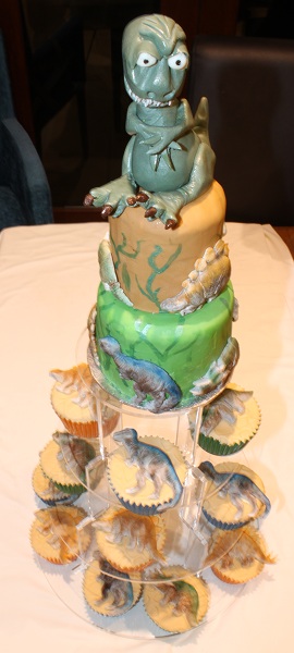 Dinosaur top tier cake with 12 dinosaur cupcakes