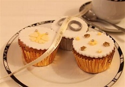 Wedding rings and butterfly cupcake